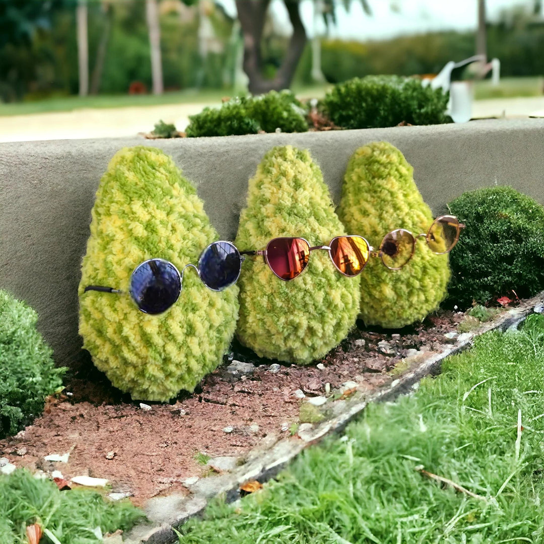 Three topiary bushes wearing stylish sunglasses, representing the fun and unique personality of Hashies® terpene-infused plushies, blending nature, relaxation, and style.